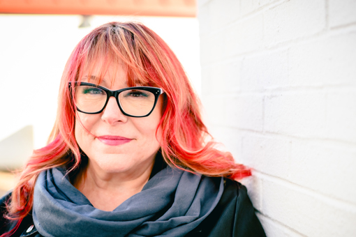 Heather Spratt - headshot, wearing black glasses with red hair and a leather jacket - death doula end of life celebrant st. johns, nl